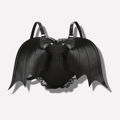 Black bat-shaped backpack with decorative elements on a light gray background