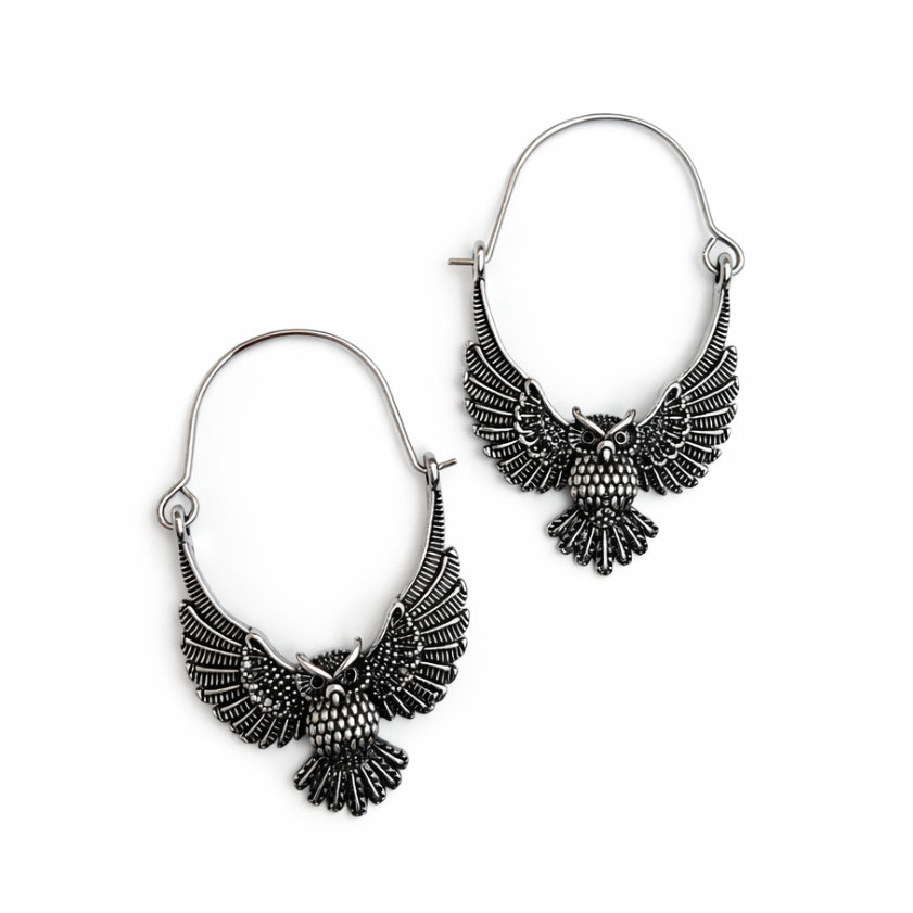 Pair of silver owl-shaped earrings on a white background