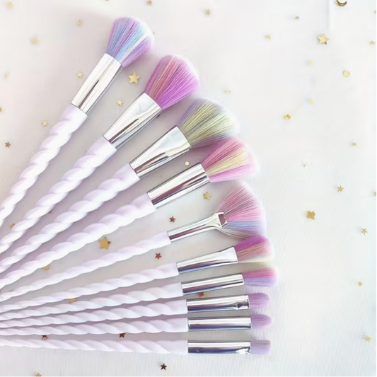 Set of makeup brushes with pastel bristles on a white background