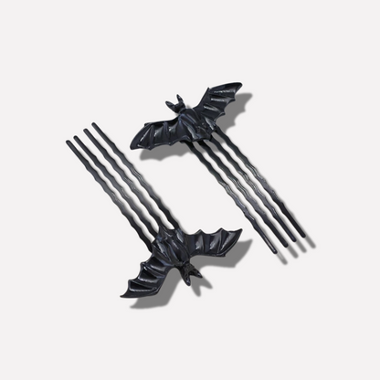 Black bat-shaped hairpins on a light gray background