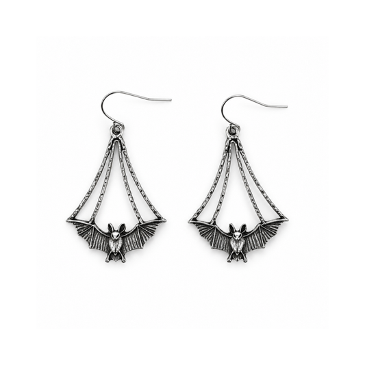 A pair of silver-toned dangle earrings featuring a bat motif with wings spread, suspended by chain-like details from fishhook wires, shown on a plain white background.