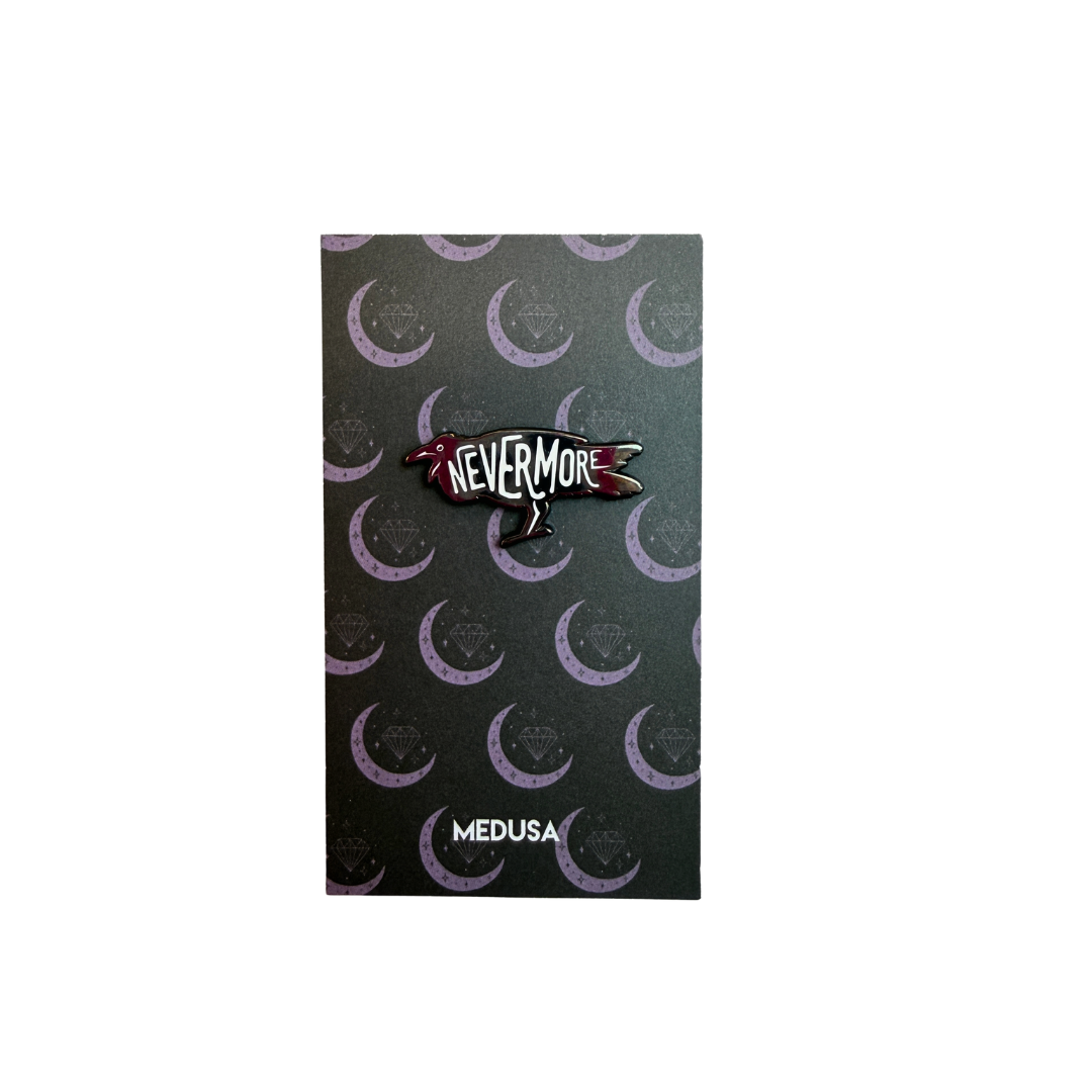 Pin with 'Nevermore' design on a black card with crescent moon pattern, brand 'Medusa' visible.