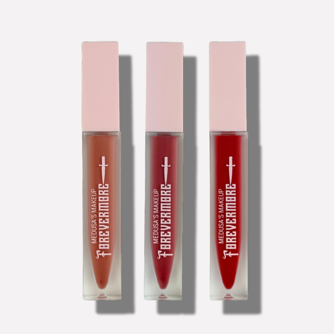 Three lip glosses with pink caps and red shades on a white background