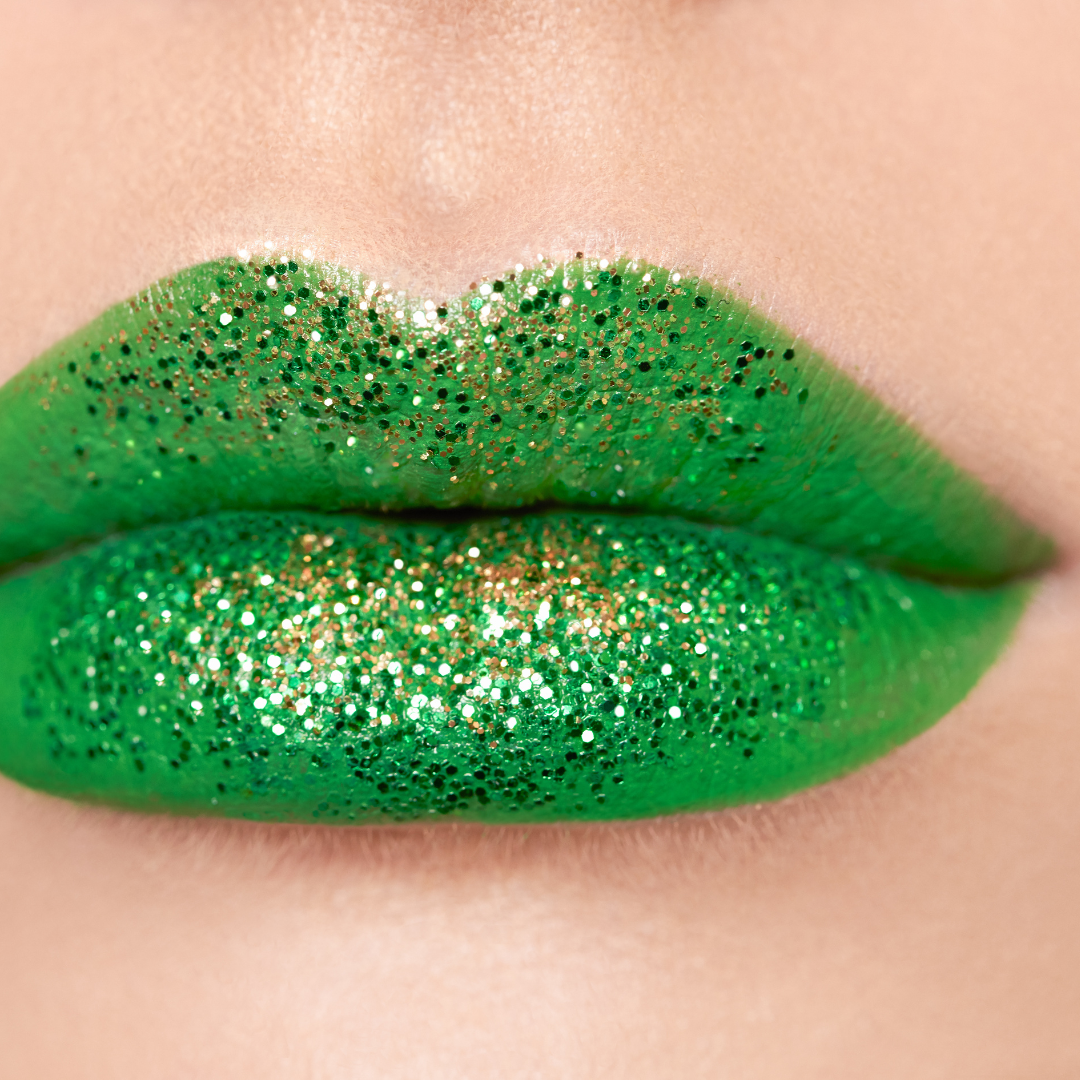 Close up of models lips wearing green lipstick with glitter on lips