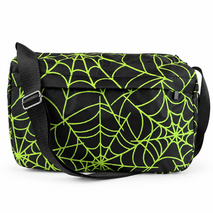 A black messenger bag with a bright neon green spiderweb pattern, featuring a black adjustable shoulder strap with a silver buckle.