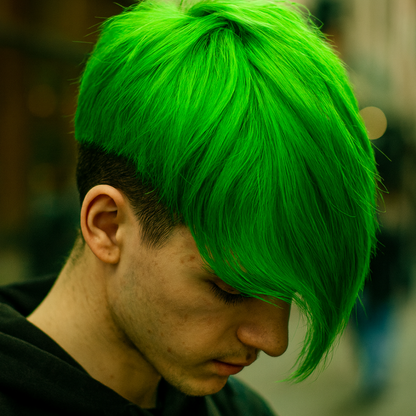 Person with bright green hair and a black shirt, looking downwards.