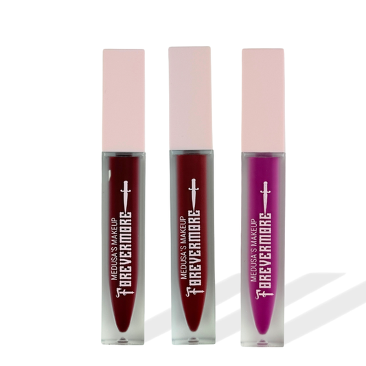 Three lip glosses with pink caps and visible branding on a white background
