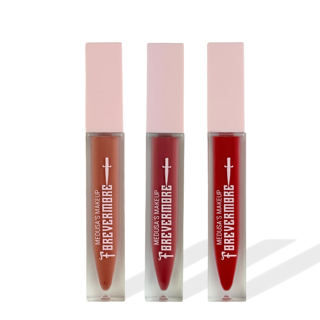Three lip glosses with pink caps and red bases on a white background