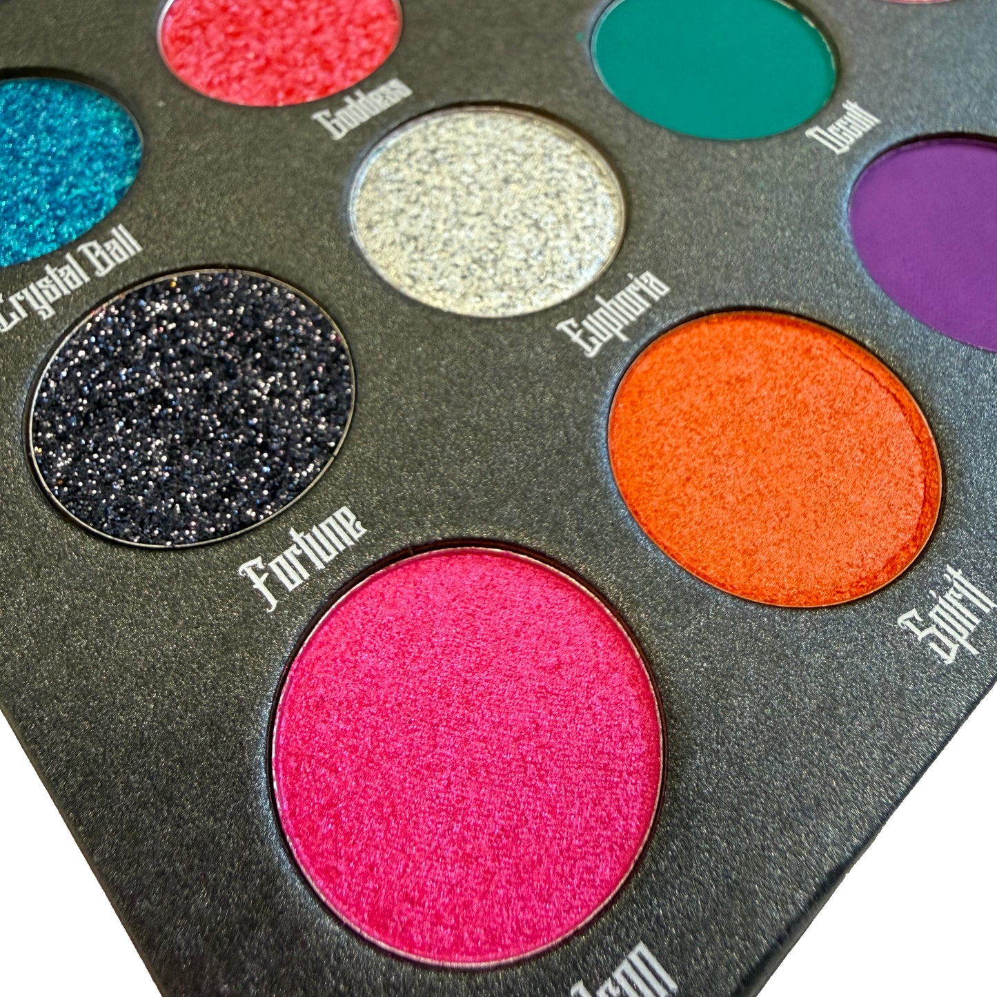 Makeup eyeshadow palette with various colors and names on a white background