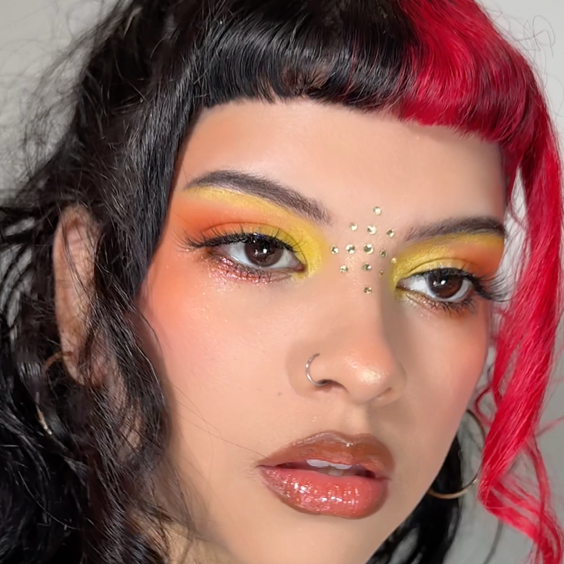 Close-up of a person with colorful makeup and hair