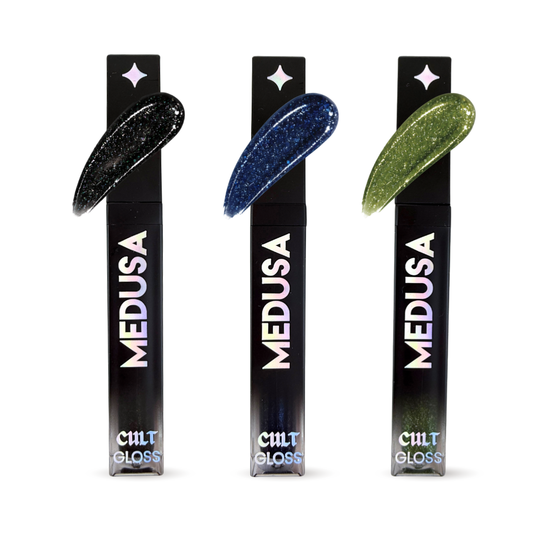 Three bottles of Cult Cosmetics Medusa Gloss with black packaging and colorful applicators on a white background.