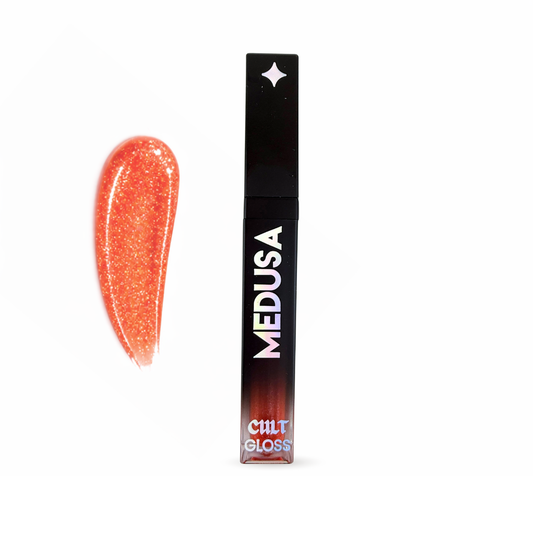 Lip gloss with glittery orange color and black packaging on a white background