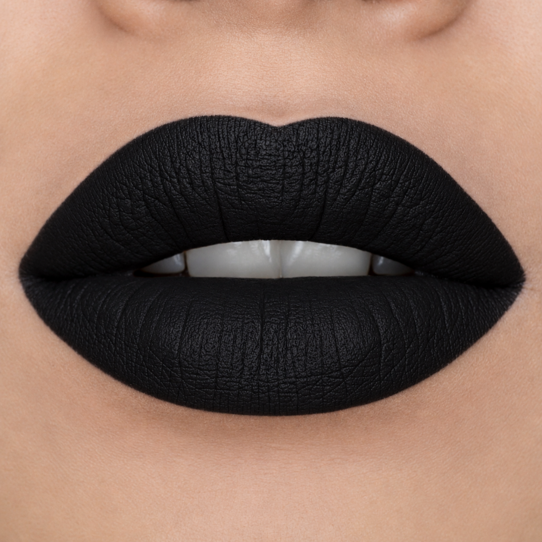 Close-up of a person's lips wearing a matte, ultra-deep black lipstick with a textured finish.