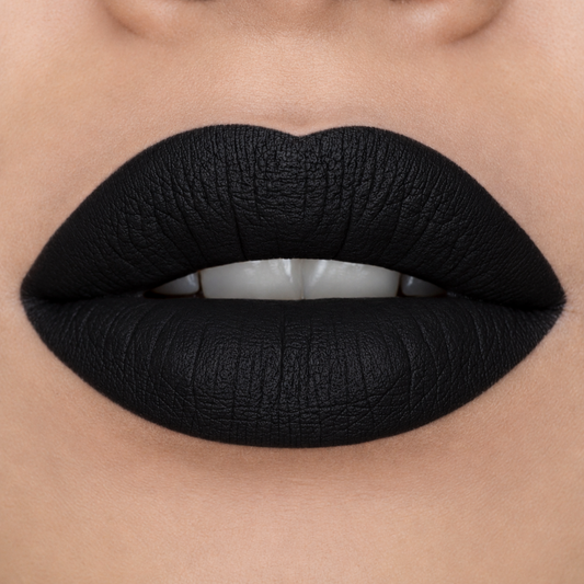 Close-up of a person's lips wearing a matte, ultra-deep black lipstick with a textured finish.