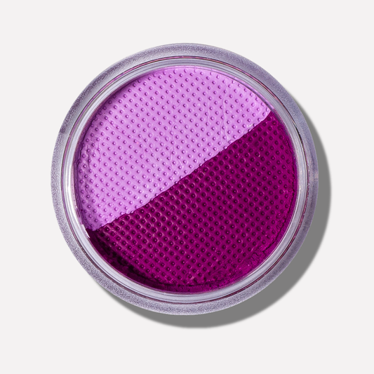 Two-tone purple makeup compact on a light background
