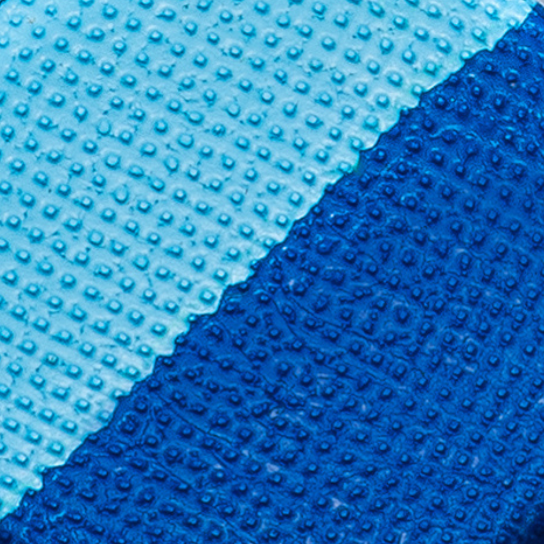 Close-up of blue textured material with a gradient from light to dark blue.