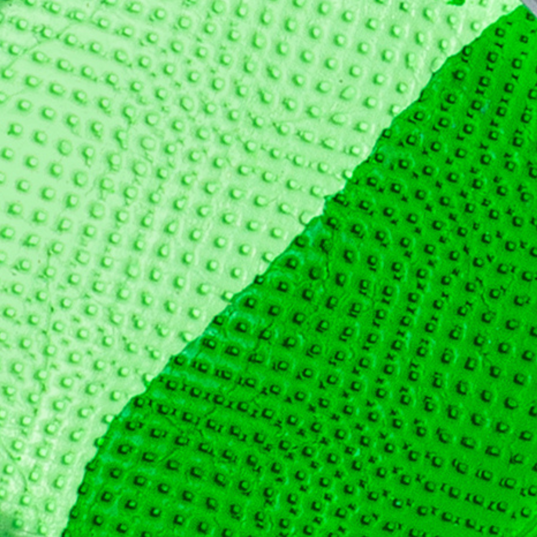 Close-up of green textured fabric with a waffle pattern
