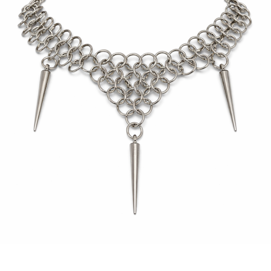 Silver chain necklace with spike-like ends on a white background