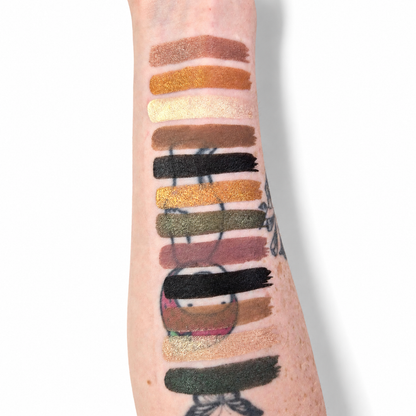 Color swatches of lipsticks applied to a person's arm on a white background