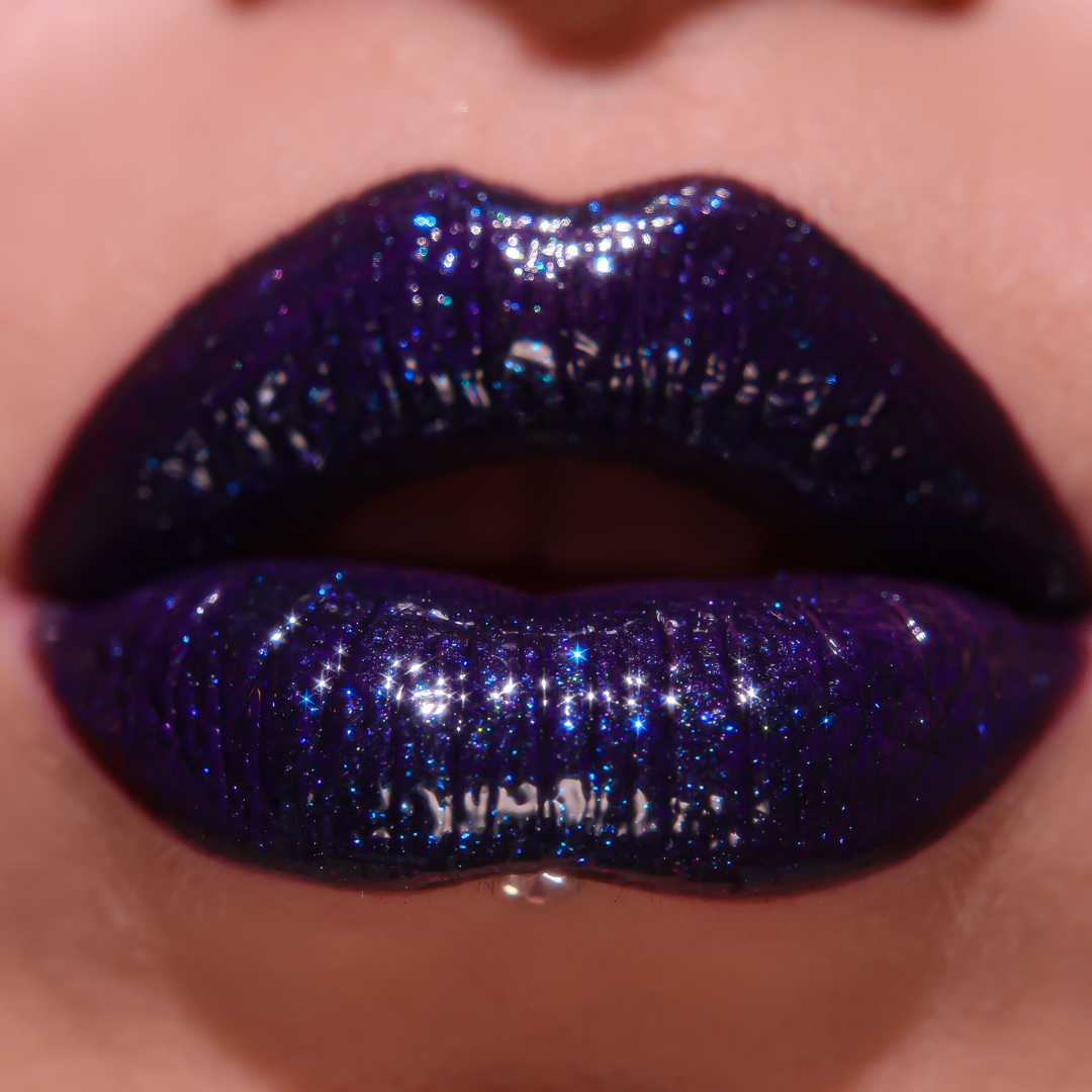 Close-up of lips with dark purple glittery lipstick