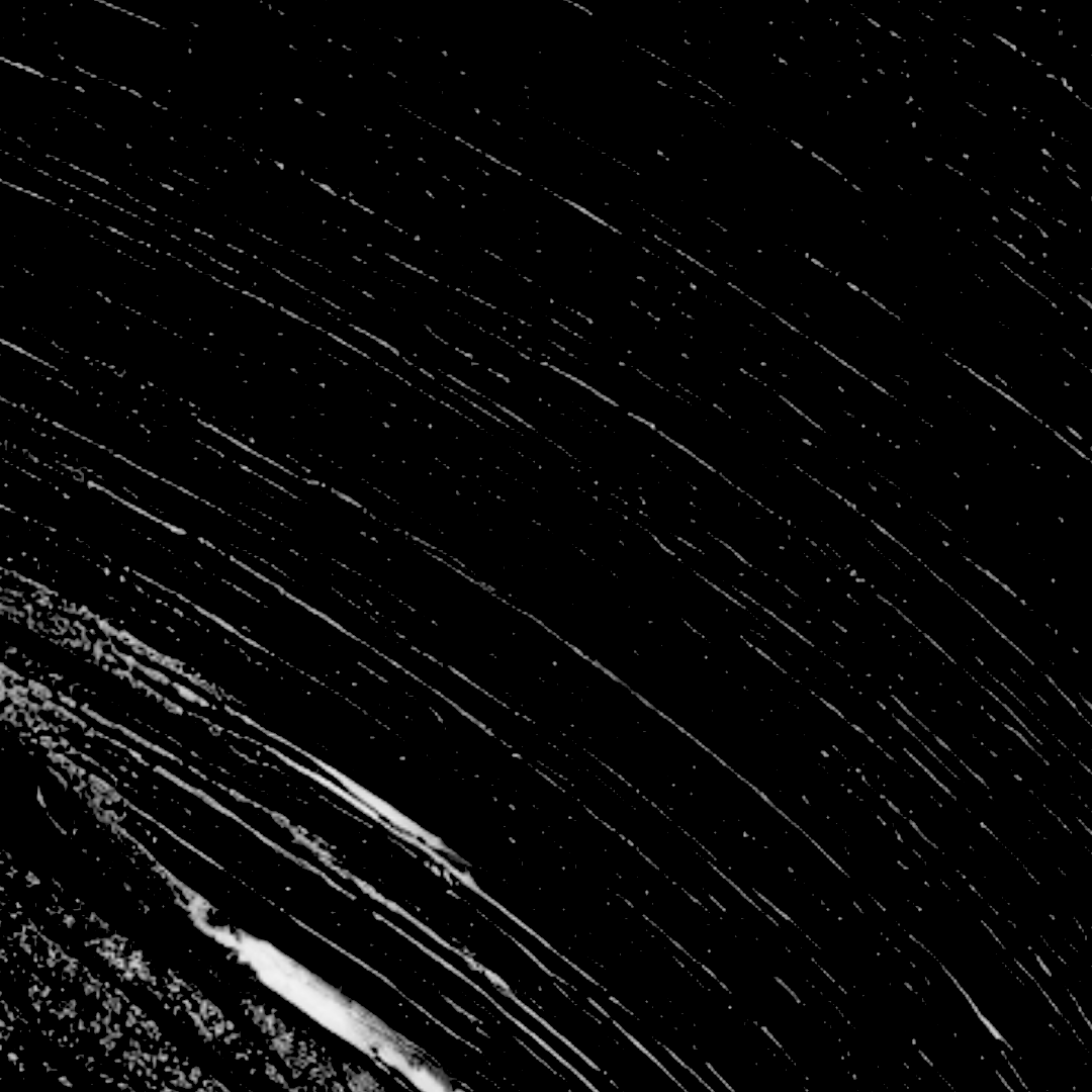 Black-and-white abstract texture with diagonal white streaks and speckles on a black background.