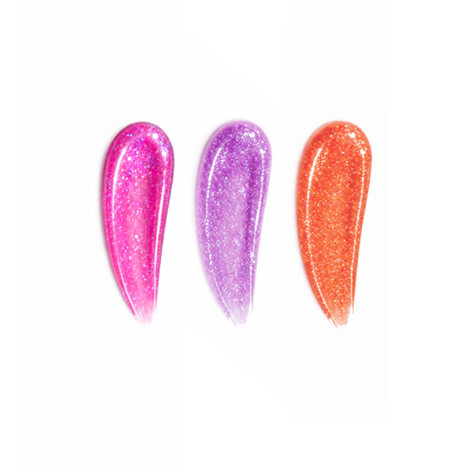Three glittery nail polishes in pink, purple, and orange on a white background
