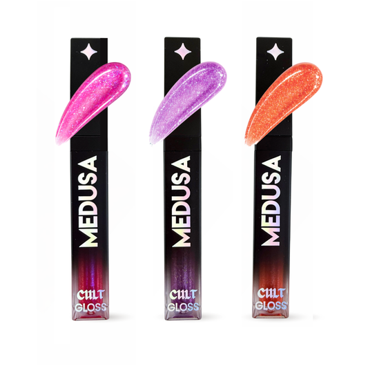 Three packaging tubes of Cult Cosmetics Medusa Gloss with colorful lip swatches on a white background.