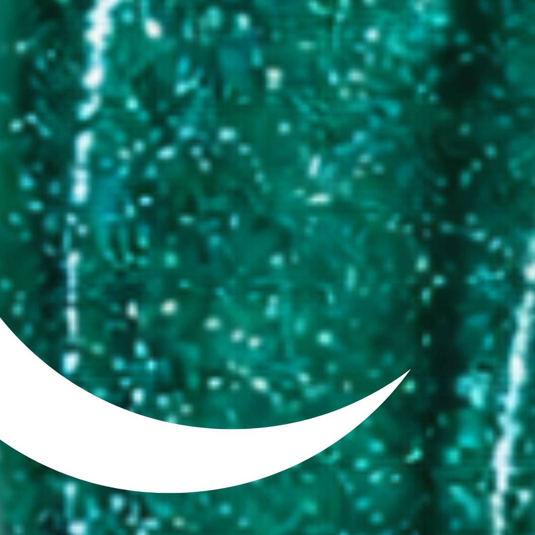 Close-up of green glittery material with a white crescent moon shape.