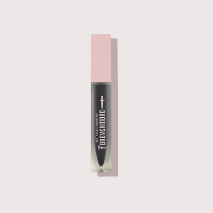 Lip gloss with pink packaging on a light gray background