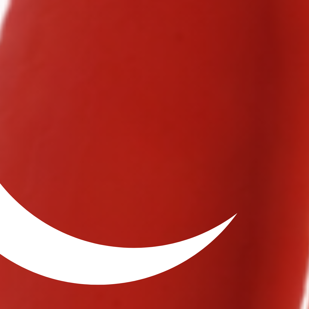 Close-up of a red Coca-Cola bottle with a white straw.