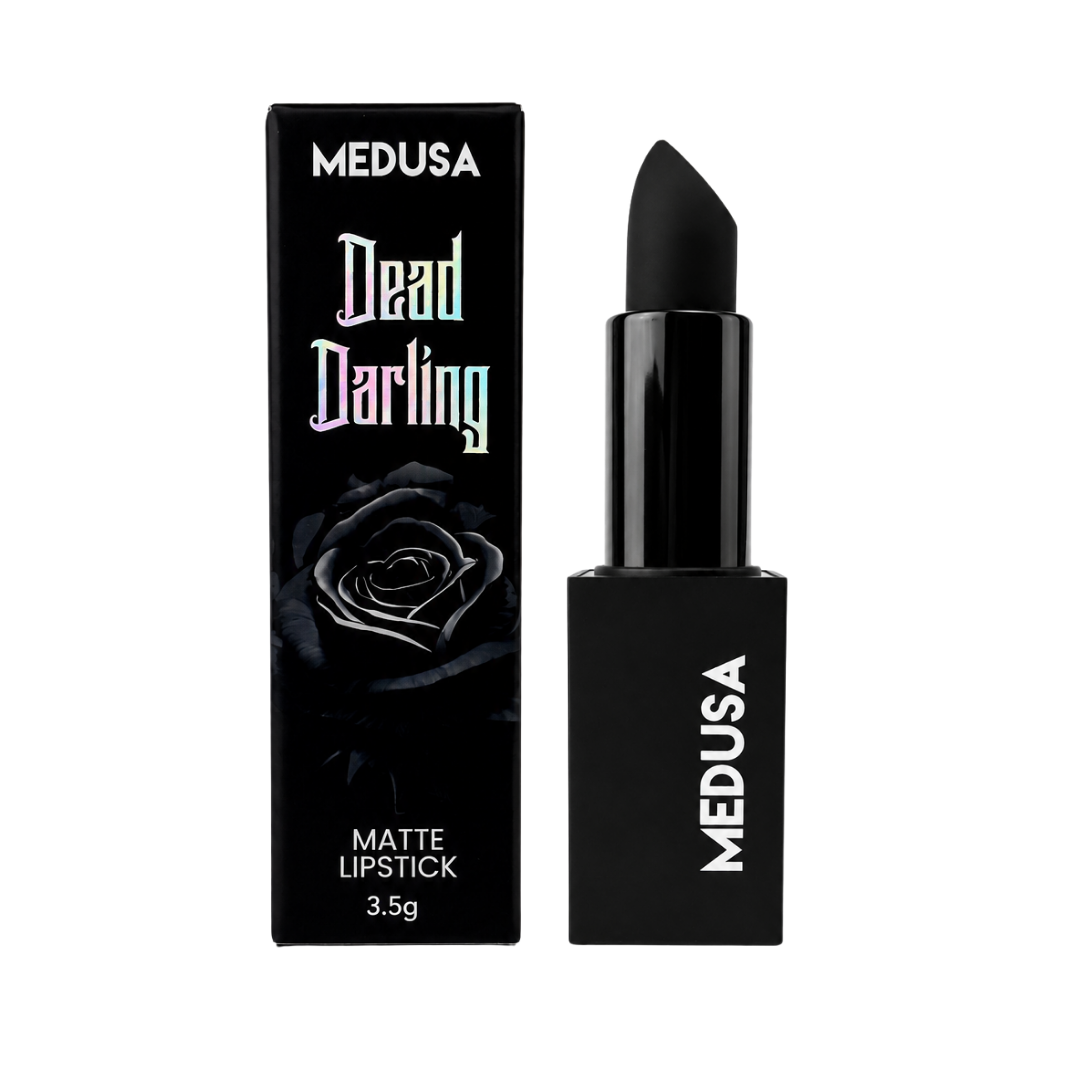 MEDUSA Dead Darling matte lipstick in a sleek black tube next to its black packaging box, featuring a gothic rose graphic and the product name in stylized lettering.