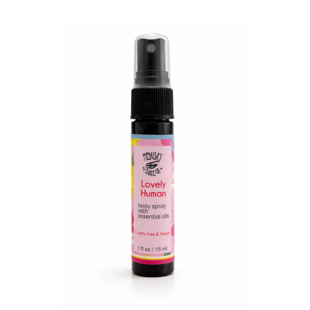 Body spray bottle with pink label on a white background