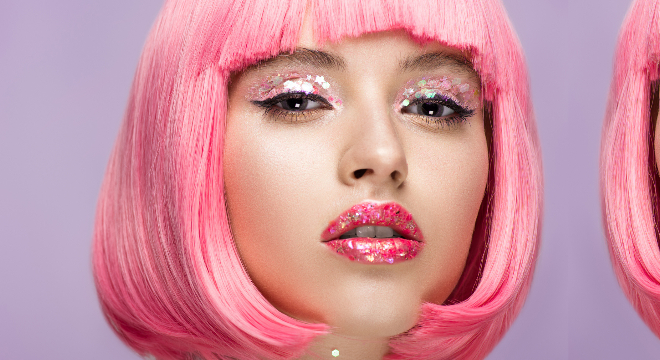 Model with pink hair wearing glittergasm glitter eyeshadow on her eyes and lips