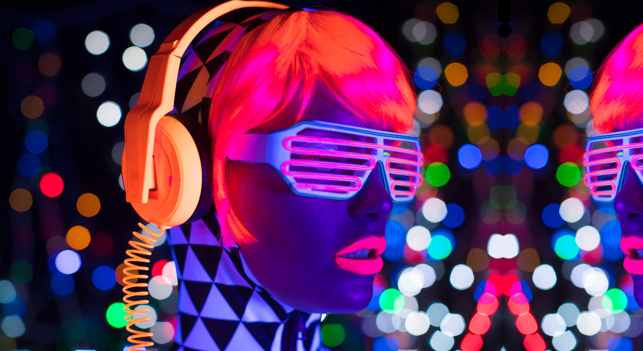 DJ Model wearing cyber sunglasses, neon headphones, neon lipstick, neon hair