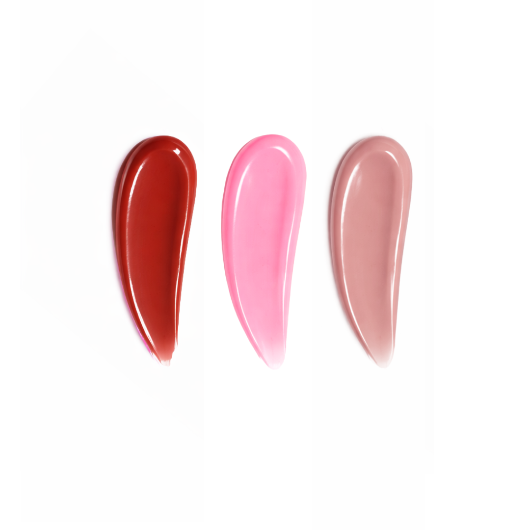Three lip gloss swatches in red, pink, and beige on a white background