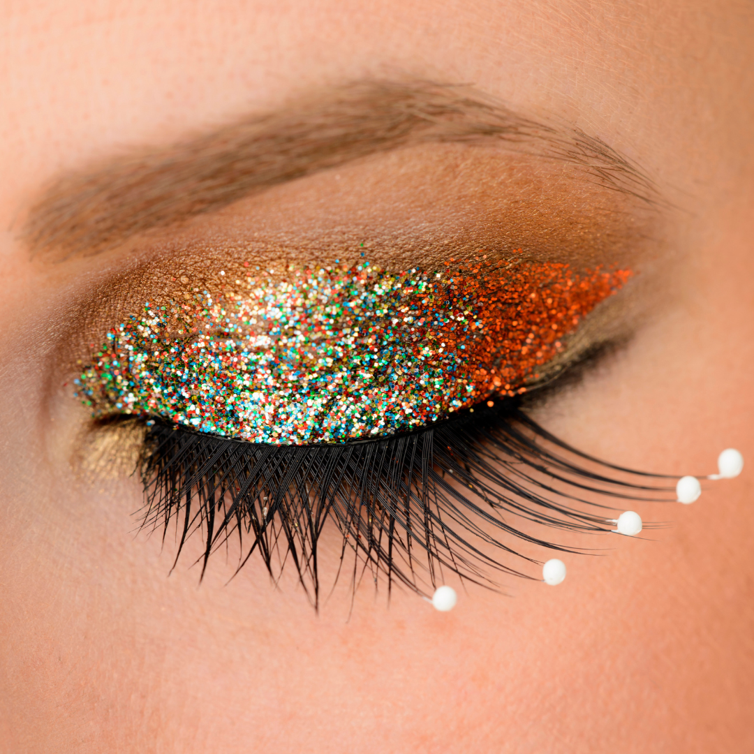 Close up of model's eye wearing gold glitter eyeshadow