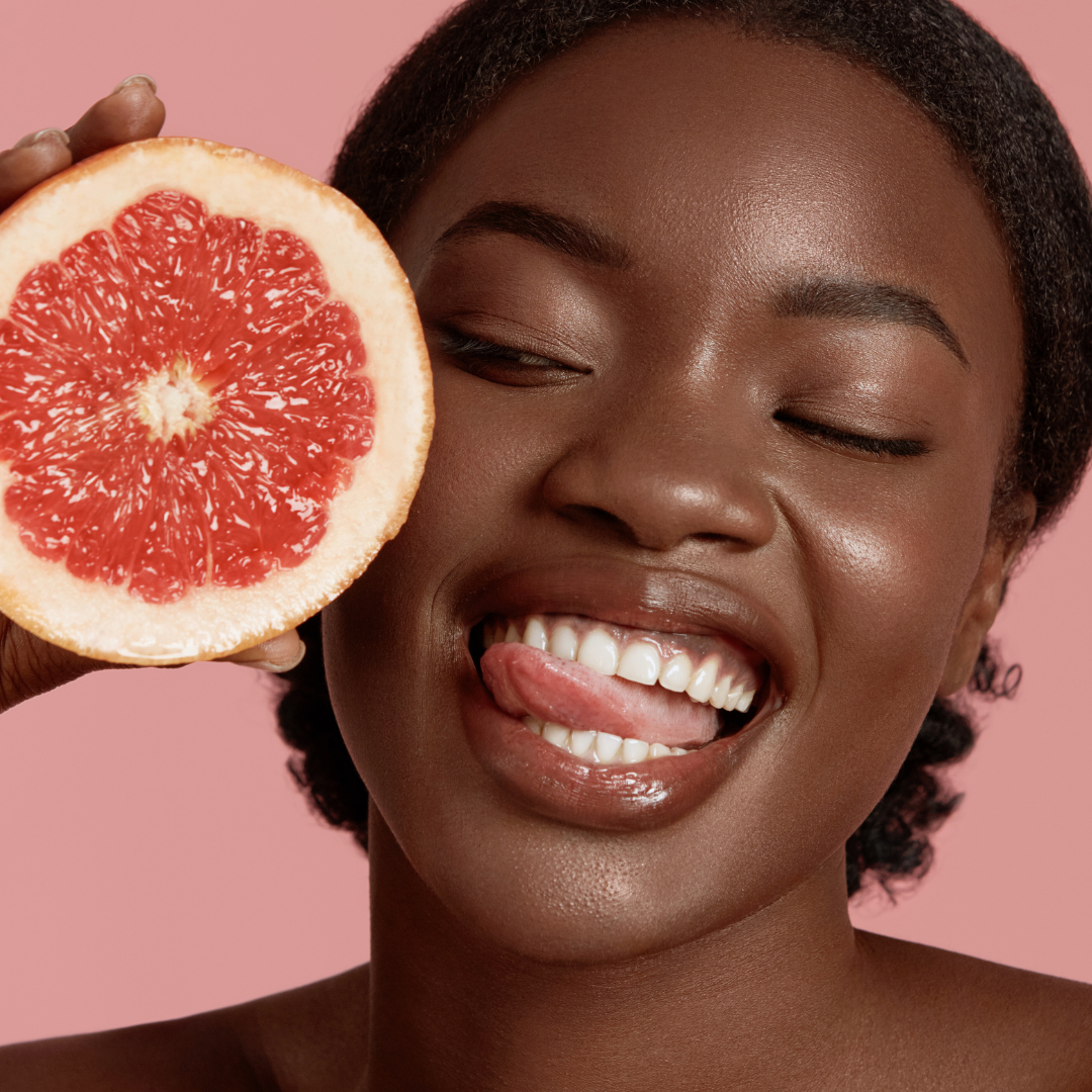 model holding a grapefruit