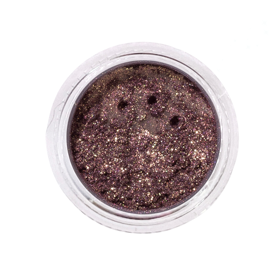 Metallic glittery powder in a small round container on a white background