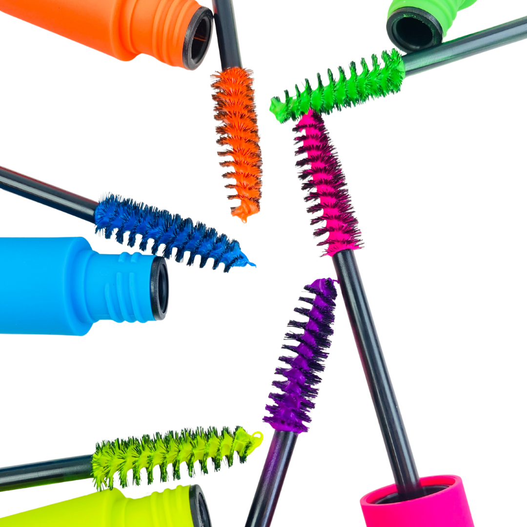 Colorful mascara brushes with various bristle designs on a white background