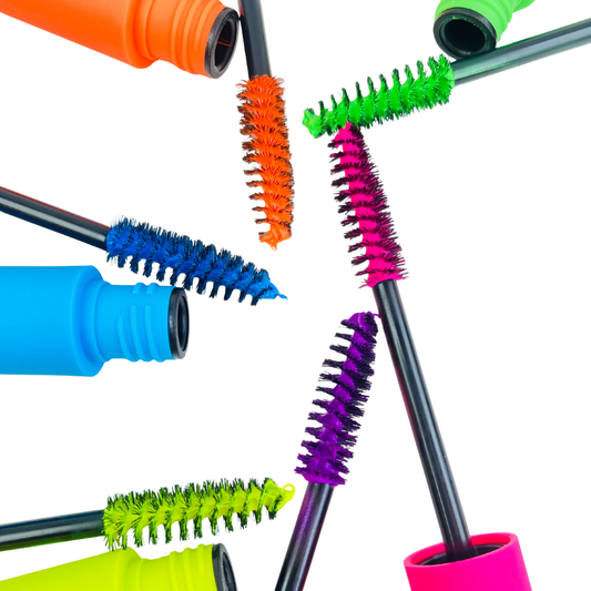Colorful mascara brushes with various bristle designs on a white background