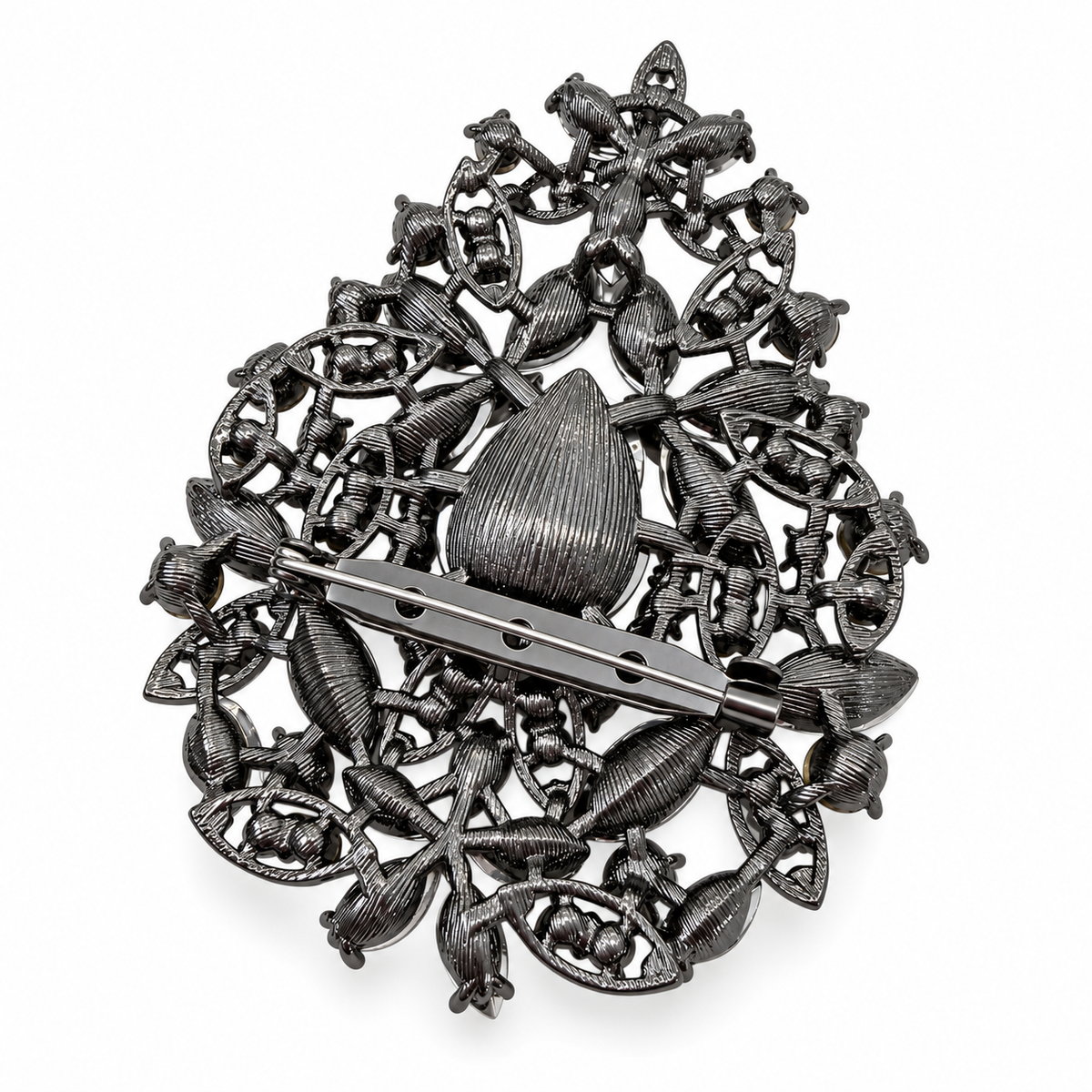 A vintage silver filigree brooch featuring a central teardrop motif, intricate floral and leaf patterns, and a barrette pin clasp, shown on a plain white background.