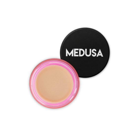 Cosmetic compact with beige powder and black lid featuring 'MEDUSA' branding on a white background.