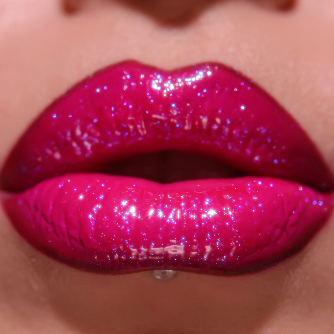 Close-up of glossy pink lips with glittery texture