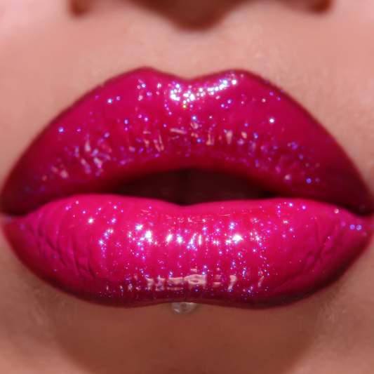 Close-up of glossy pink lips with glittery texture