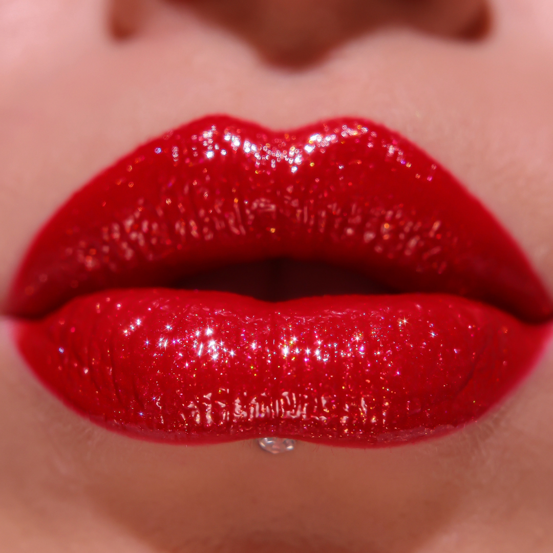 Close-up of glossy red lipstick on lips