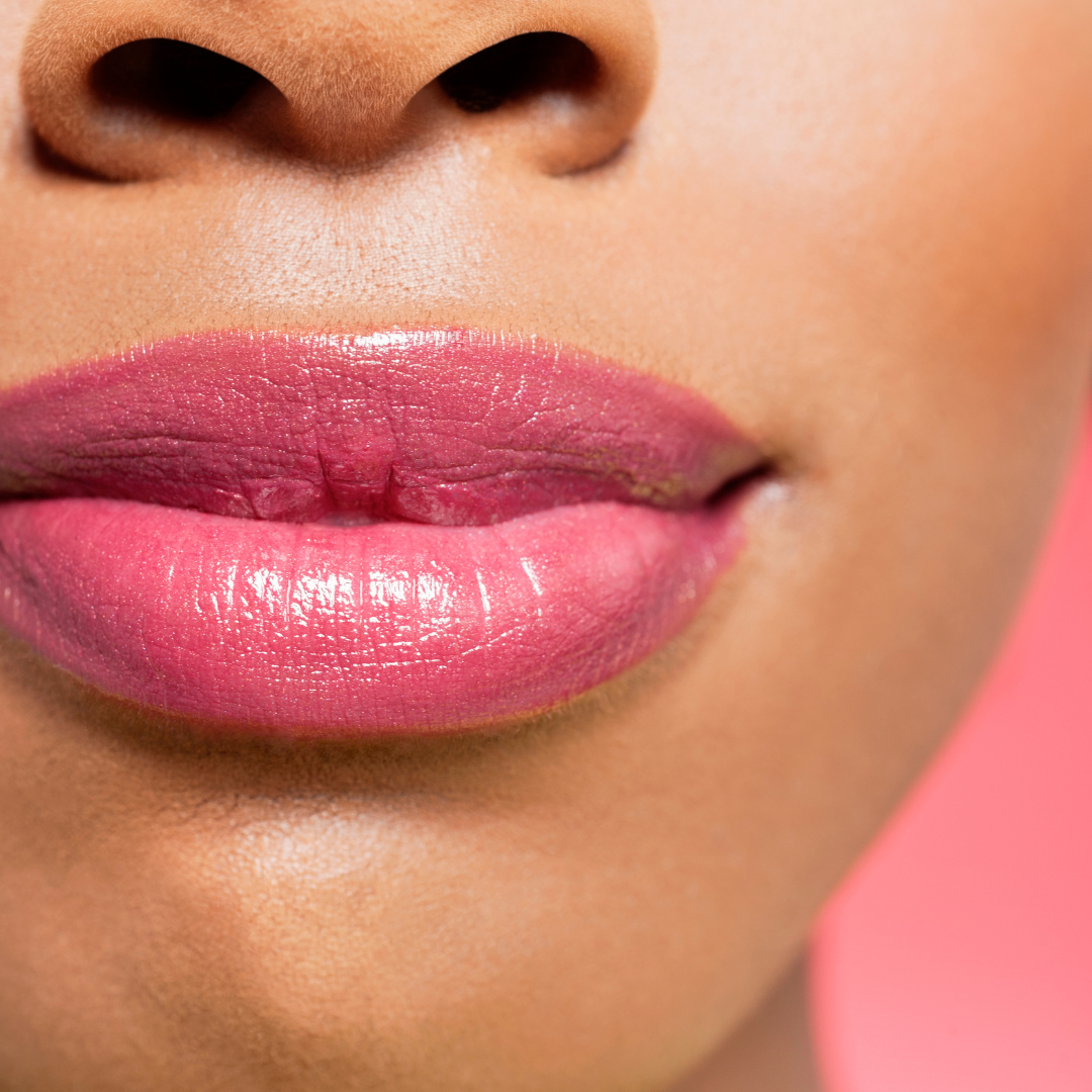 Up close of a womans's lips wearing love byrd lip balm