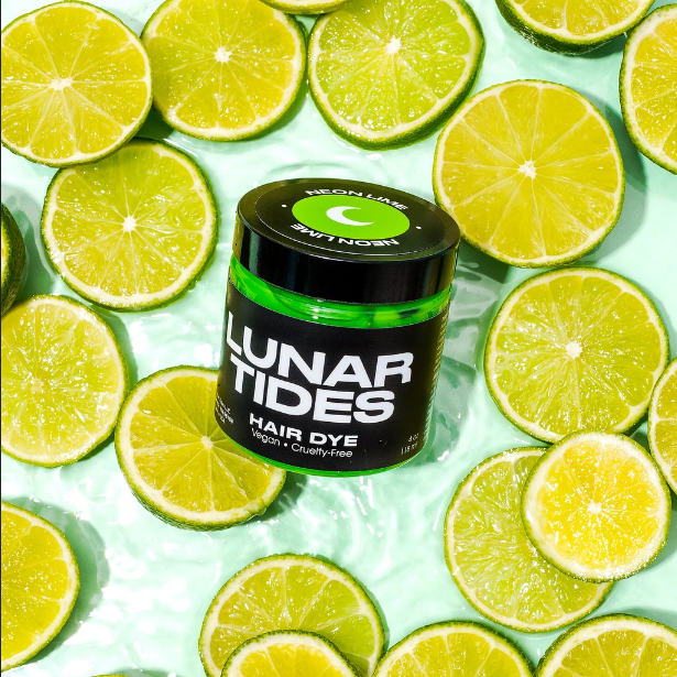 Lunar Tides Hair Dye - Neon Lime in a scenery of lime slices